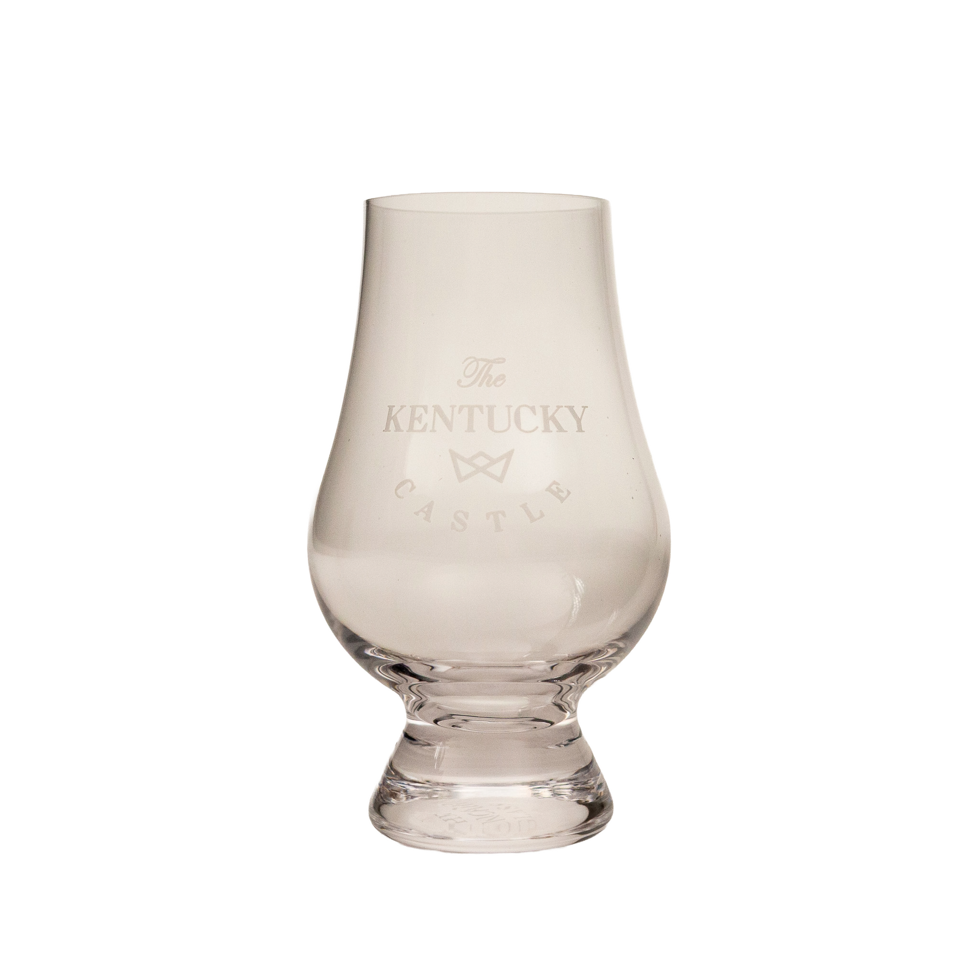 A clear glass tulip-shaped whiskey tasting glass with "Kentucky Castle" etched on it.