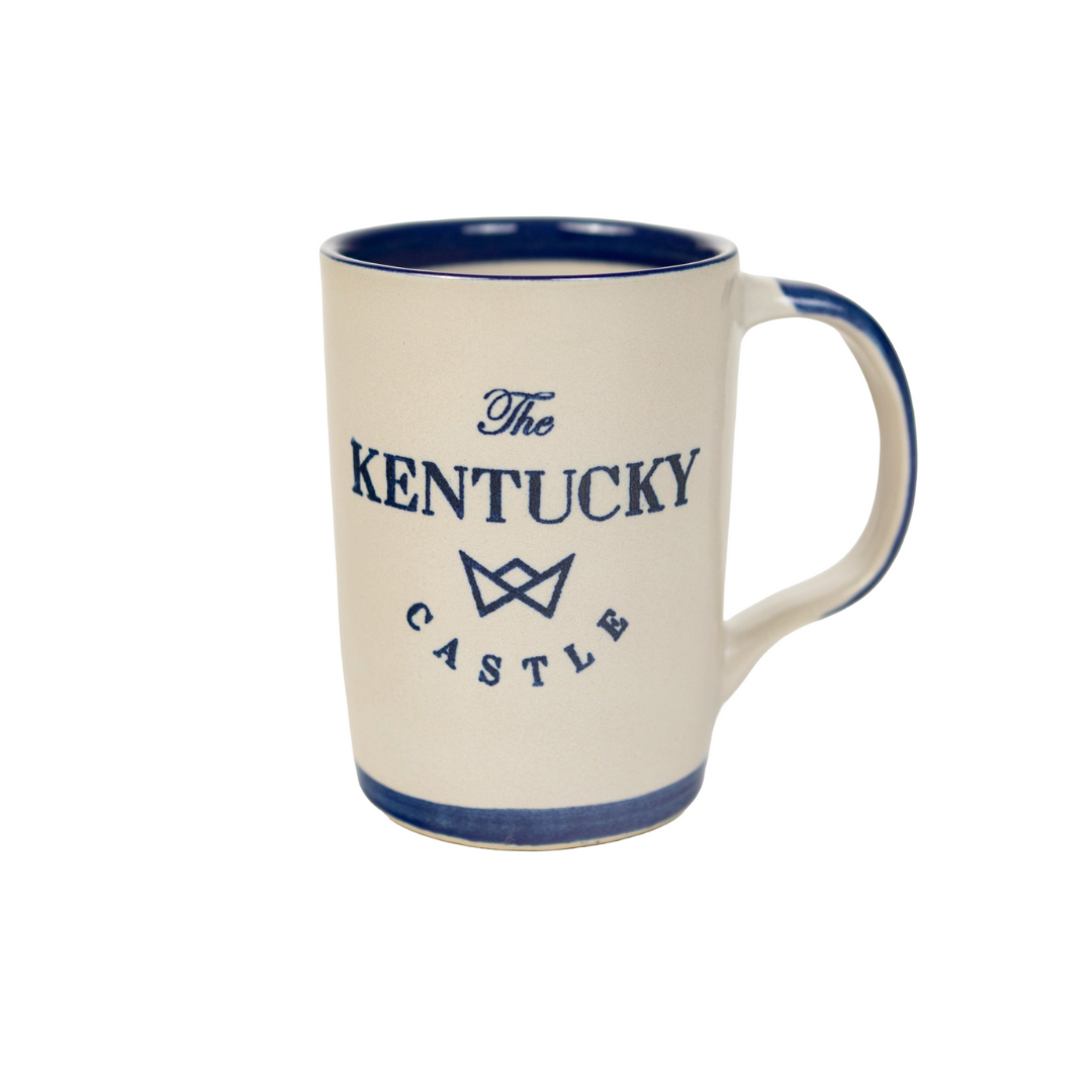 Cream-colored coffee mug with blue trim and text "The Kentucky Castle".