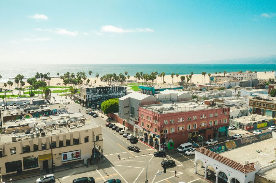An aerial view of a city with a beach in the background.