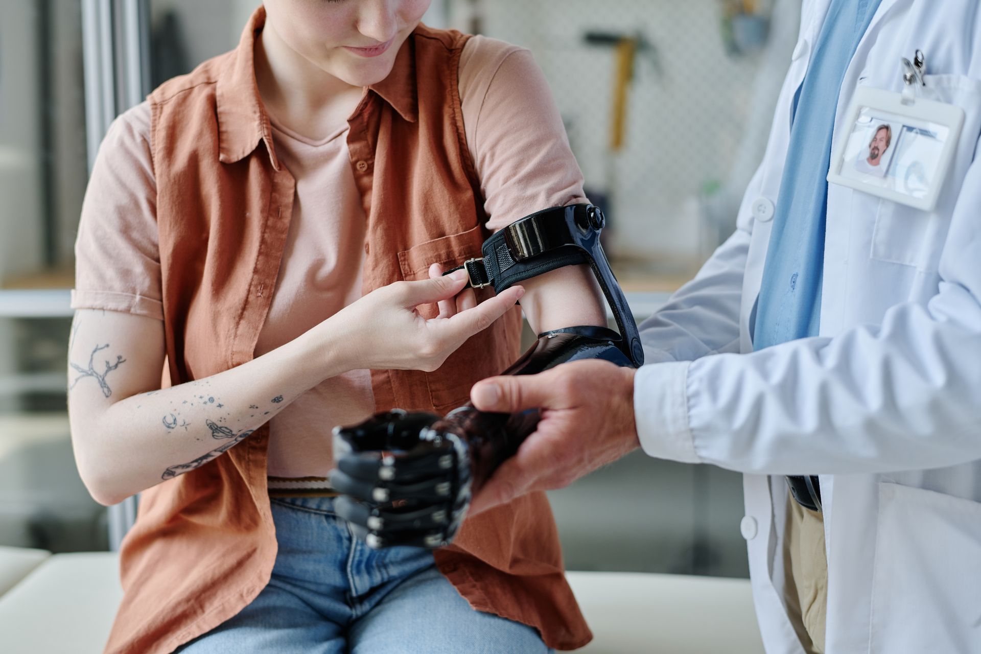 Healthcare worker fitting a blood pressure cuff on a seated patient’s arm
