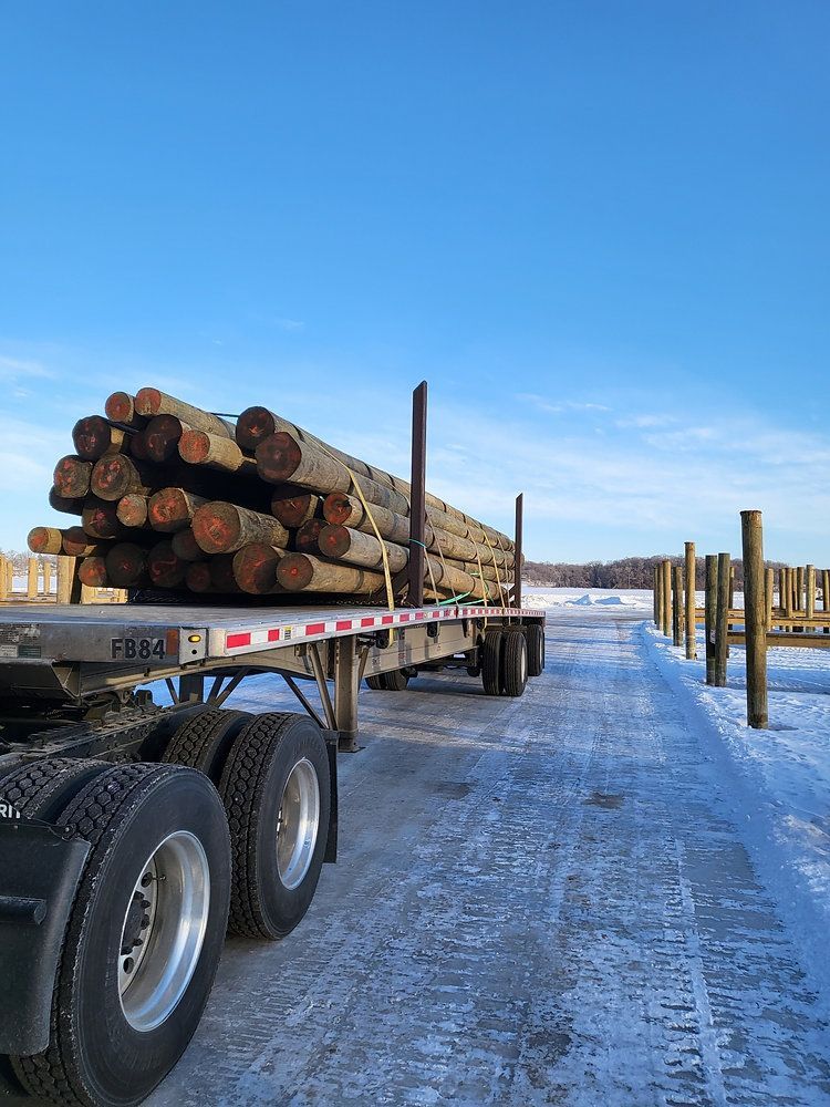 A construction worker wearing orange gloves is pouring concrete on a construction site.