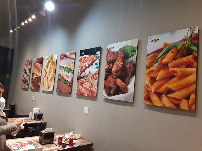 A restaurant with a lot of pictures of food on the wall