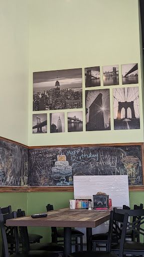 A restaurant with tables and chairs and pictures on the wall.