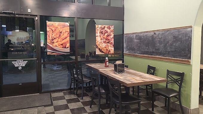 A restaurant with a table and chairs in front of a glass door.