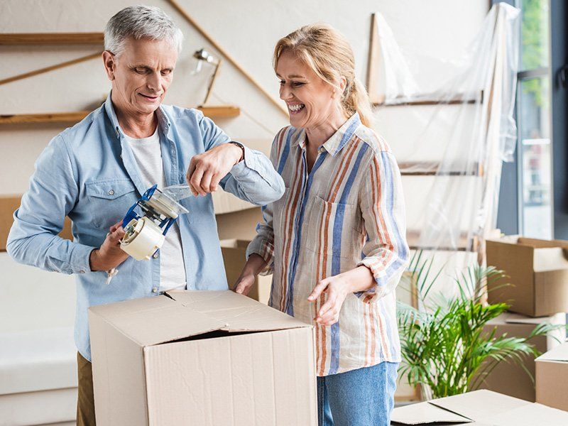 Senior Couple Packing Cardboard Boxes — Florence, AL — Florence Blvd. Self Storage