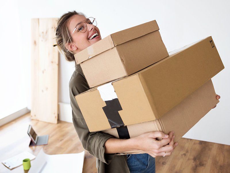 Woman Carrying Boxes — Florence, AL — Florence Blvd. Self Storage