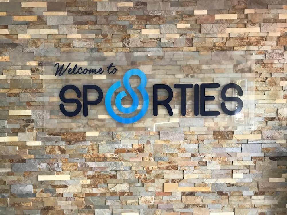 A Sign On A Brick Wall That Says Welcome To Sporties — Inverell Sporties in Inverell, NSW