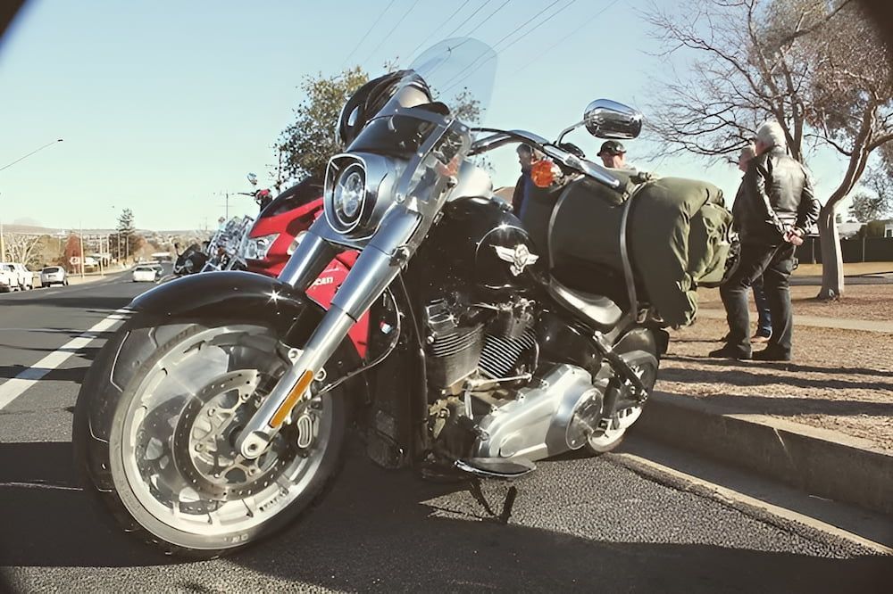 A Harley Davidson Motorcycle Is Parked On The Side Of The Road — Inverell Sporties in Inverell, NSW