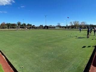 Green Bowling Green With Players, Blue Sky, and Perimeter Fencing — Inverell Sporties in Inverell, NSW