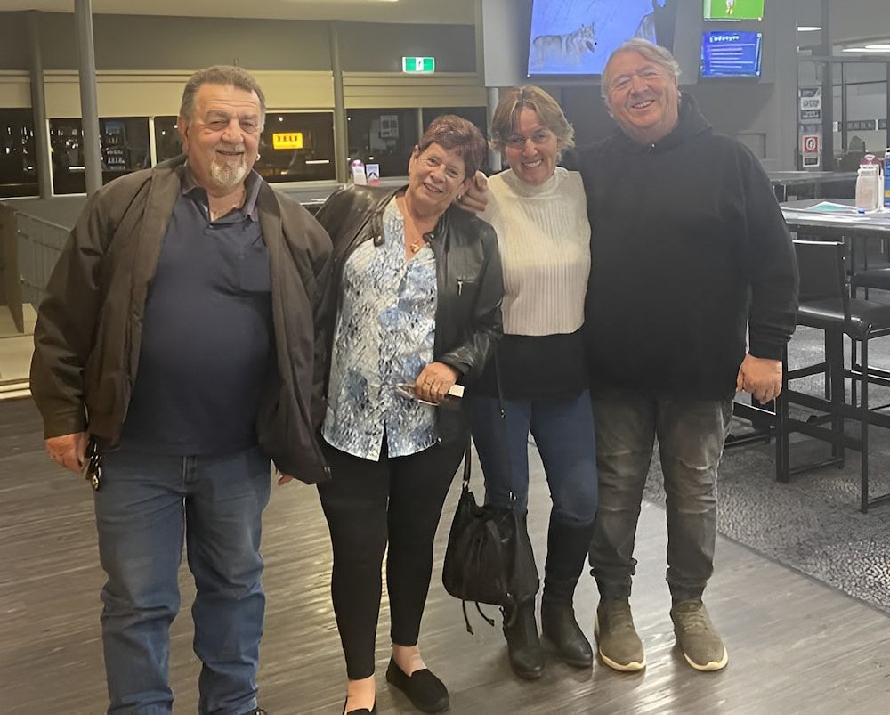 A Group Of People Are Posing For A Picture In A Restaurant — Inverell Sporties in Inverell, NSW