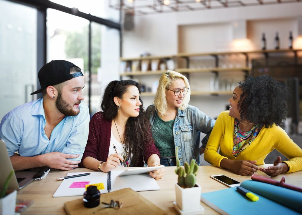 A Group Of People Are Sitting Around A Table Having A Meeting — Inverell Sporties in Inverell, NSW
