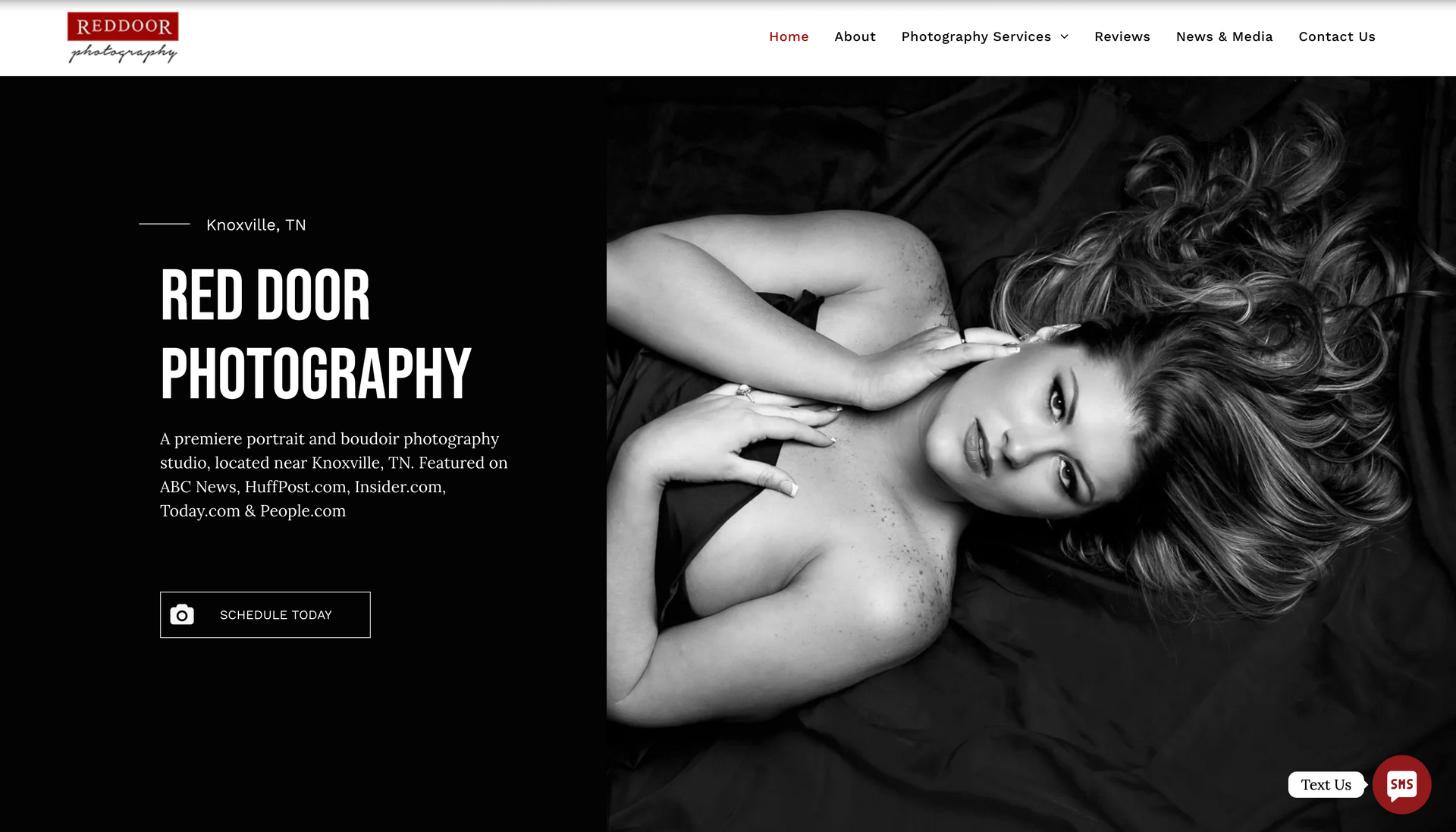 A woman is laying on a bed in a black and white photo.