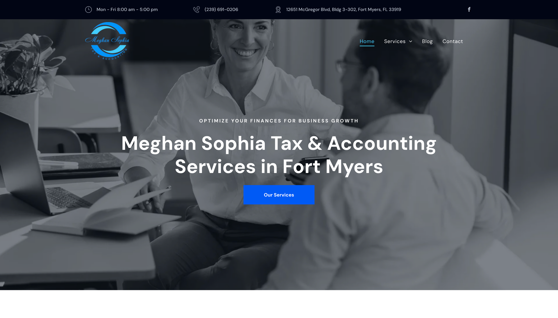 A man and a woman are sitting at a table talking to each other.