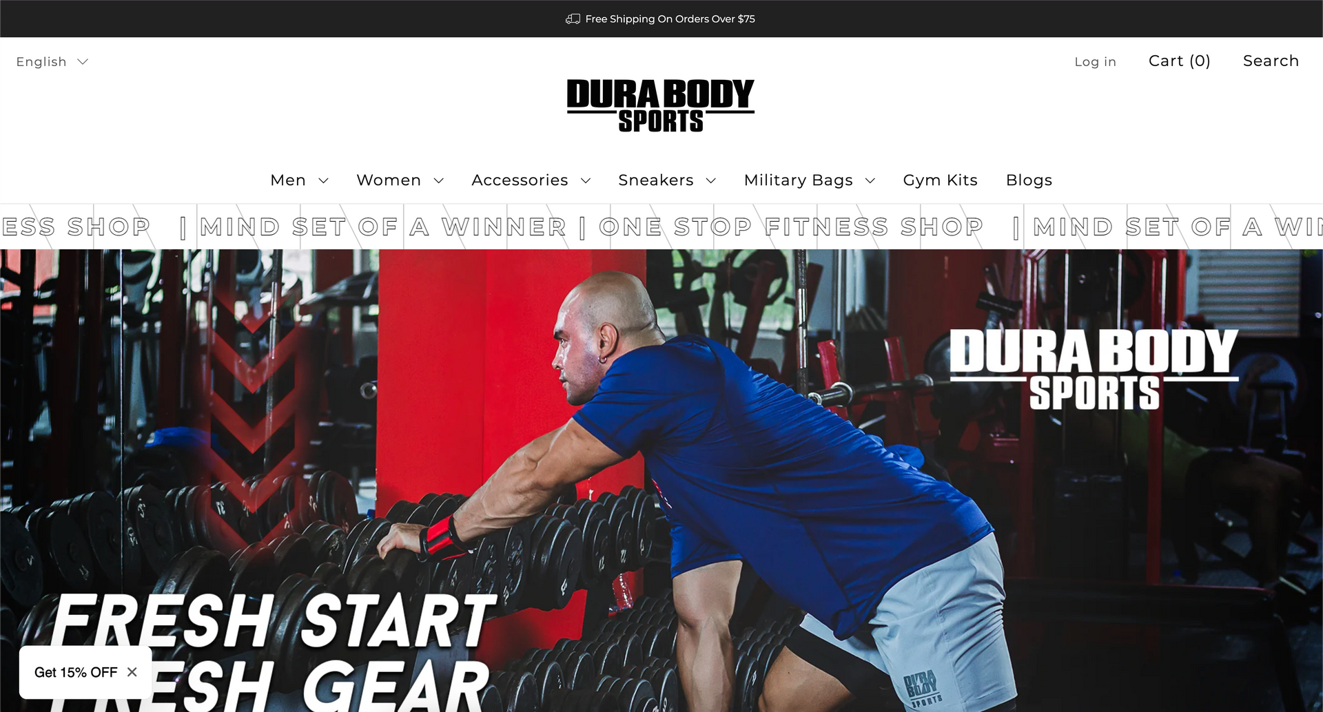 A man in a blue shirt is lifting a barbell in a gym.