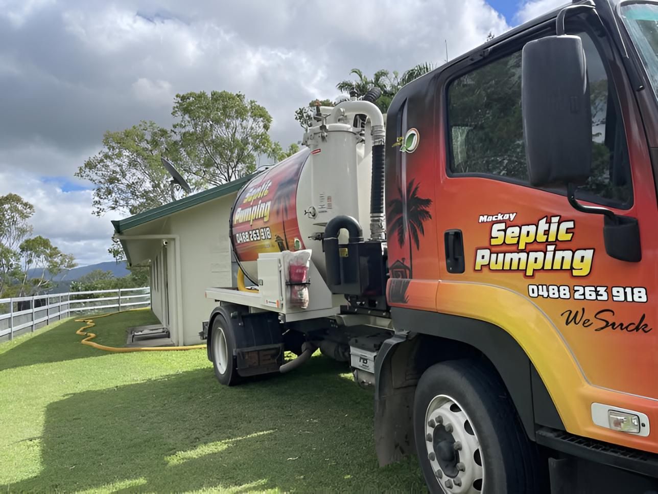 Septic Service Truck Operating in Front of a House — Mackay Septic Pumping In South Mackay, QLD