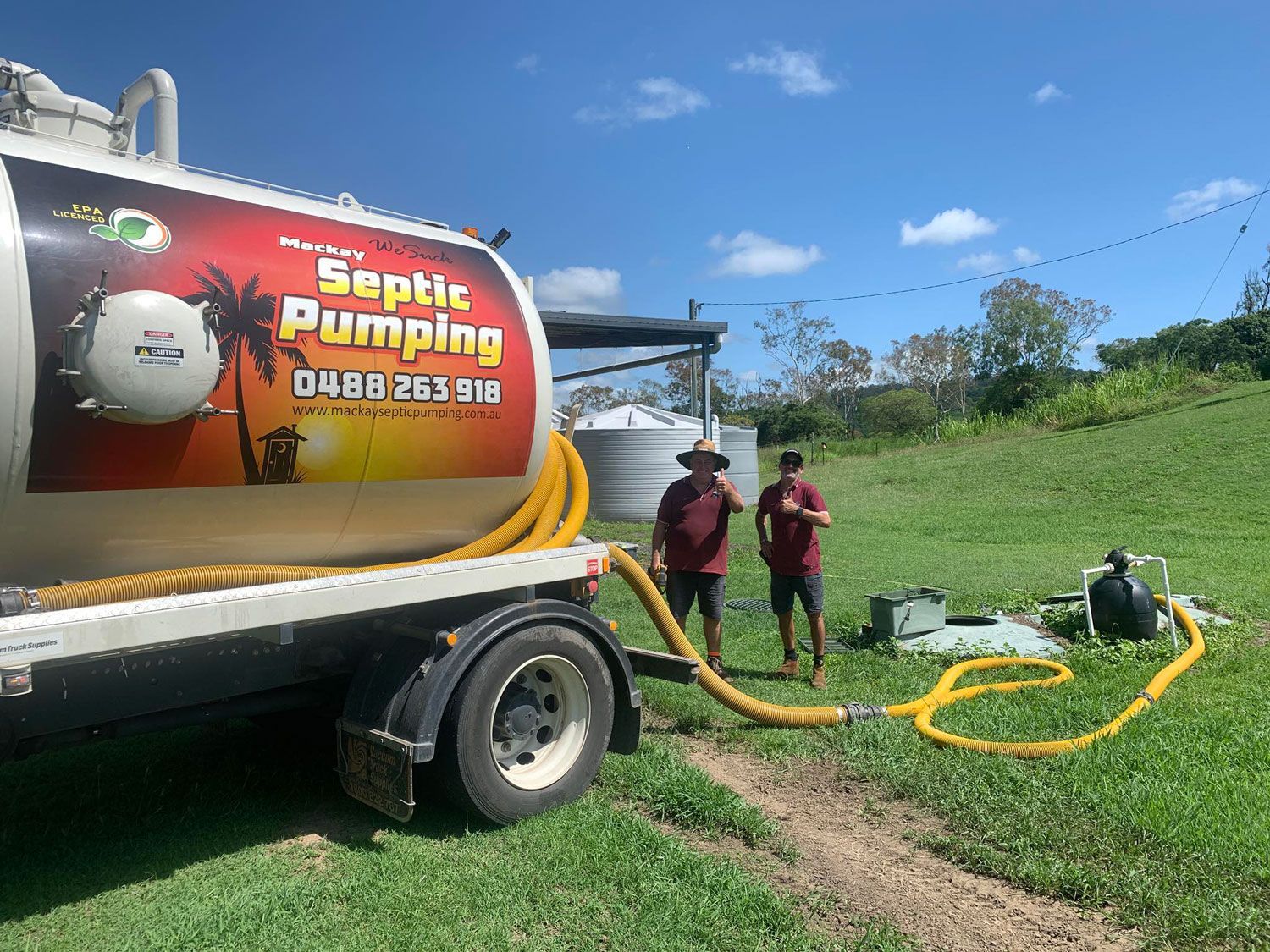 Men Standing During A Septic Tank Pump Out In Mackay