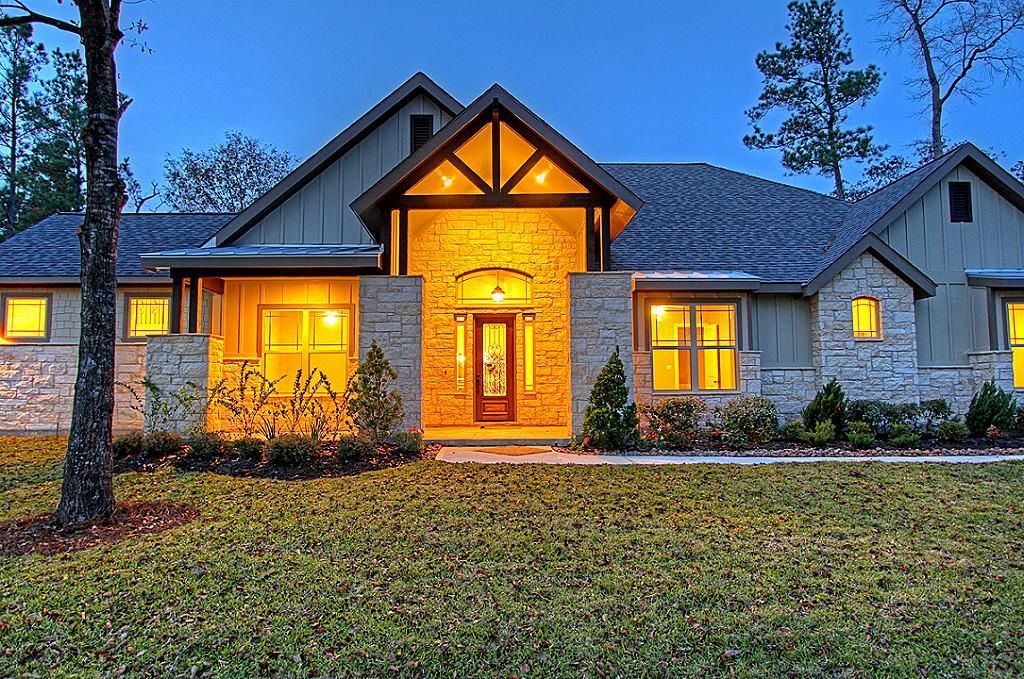 A large house with a lot of windows is lit up at night.