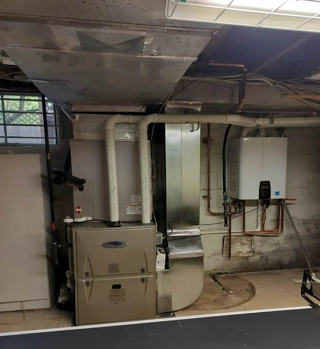 A room with a furnace and a water heater