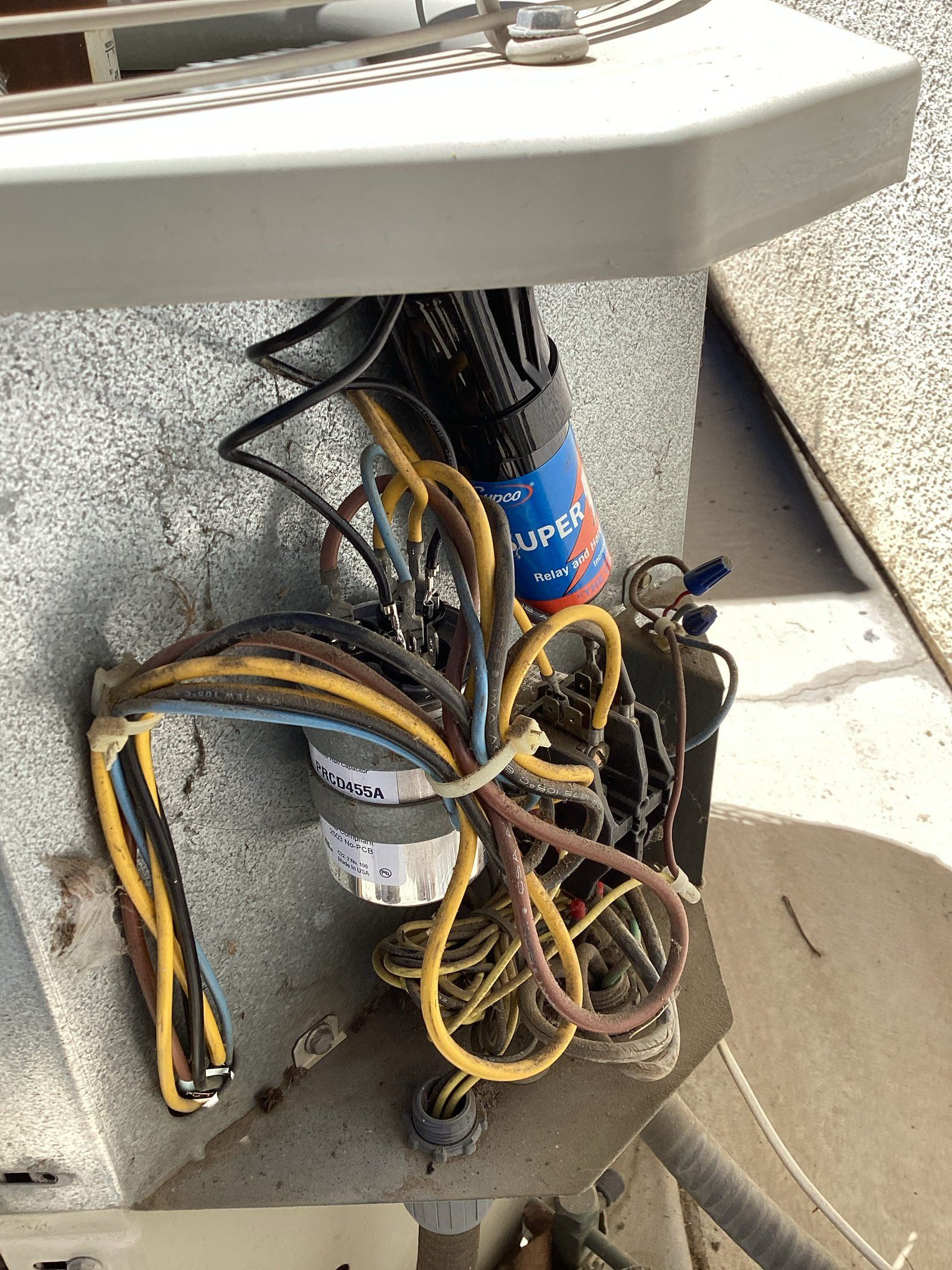 Open electrical wiring with multiple colored wires exposed.