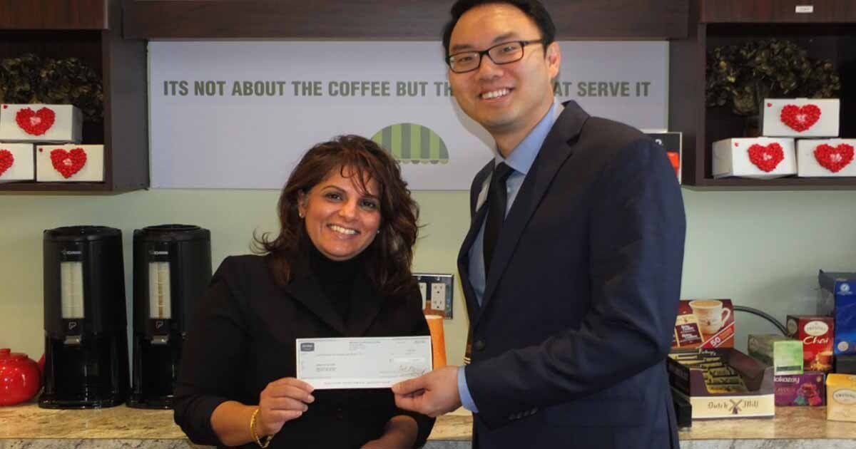 Cheque presentation to Shelley Daffu by Eugene Chan of Meridian Credit Union