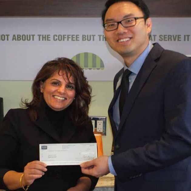 Cheque presentation to Shelley Daffu by Eugene Chan of Meridian Credit Union