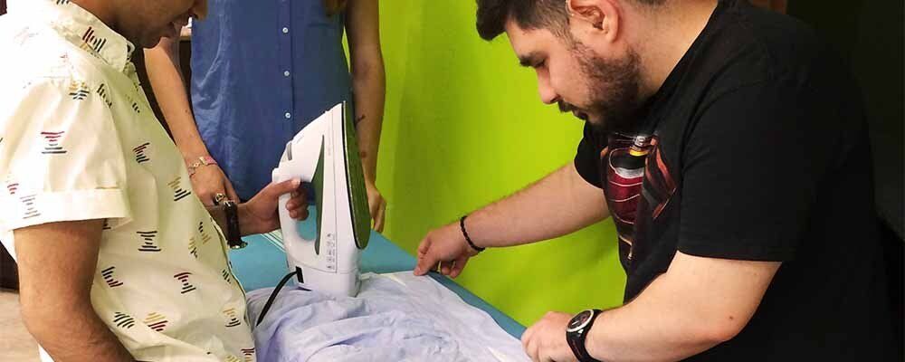 Students learning to iron