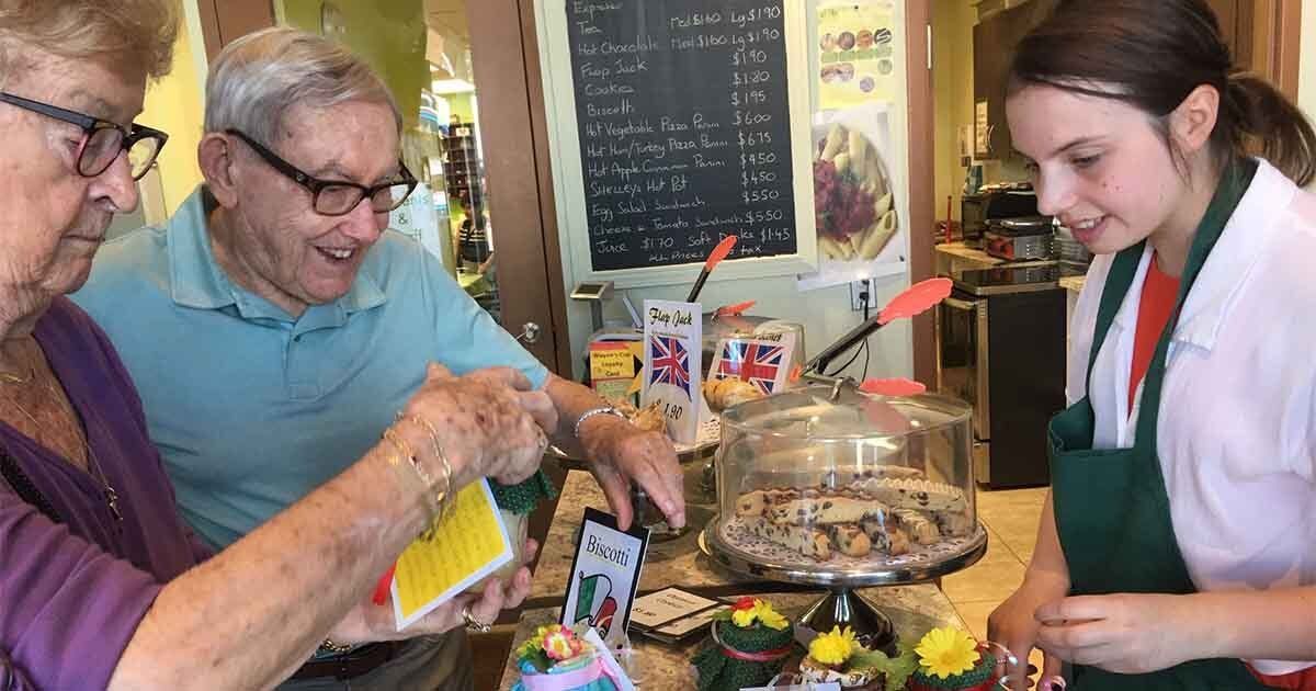 Student serving customers in Wayne's Cup Café