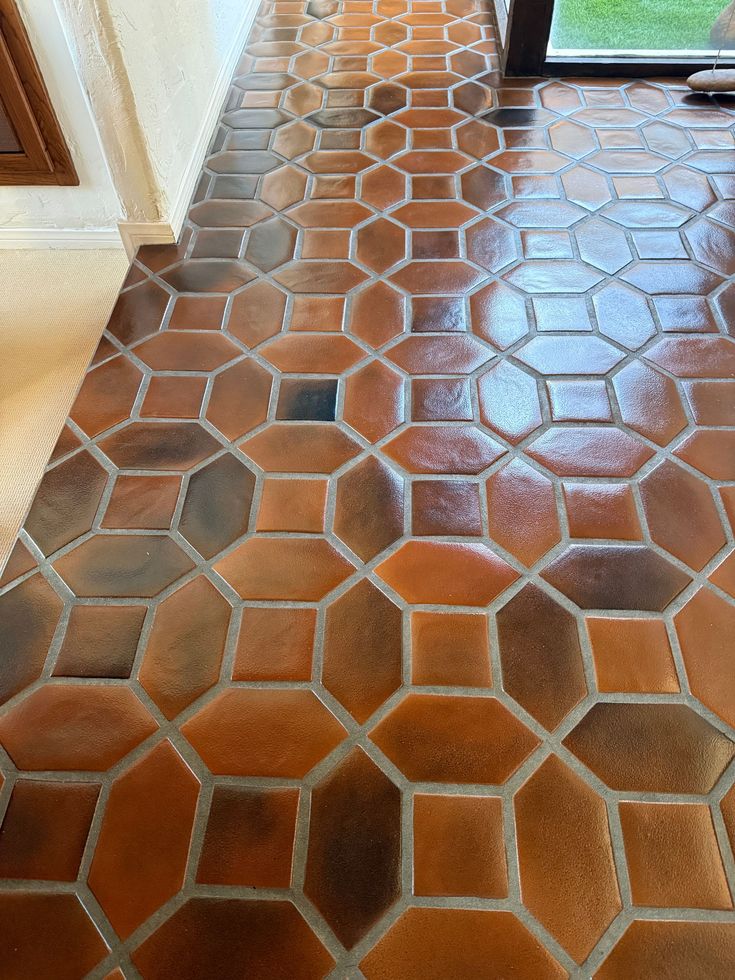 Brown and orange octagonal tile floor with light grout.