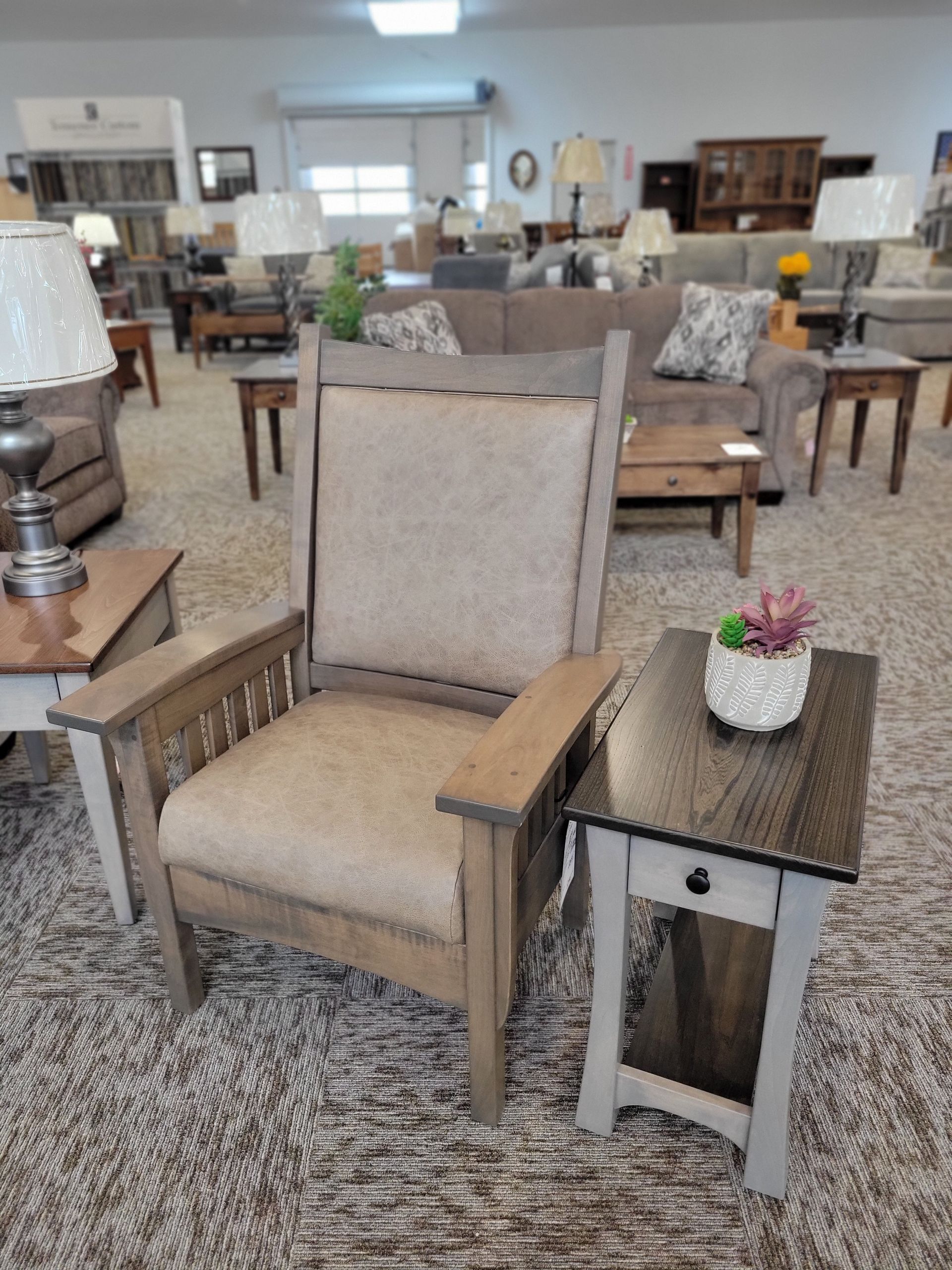 A chair is sitting next to a table in a living room