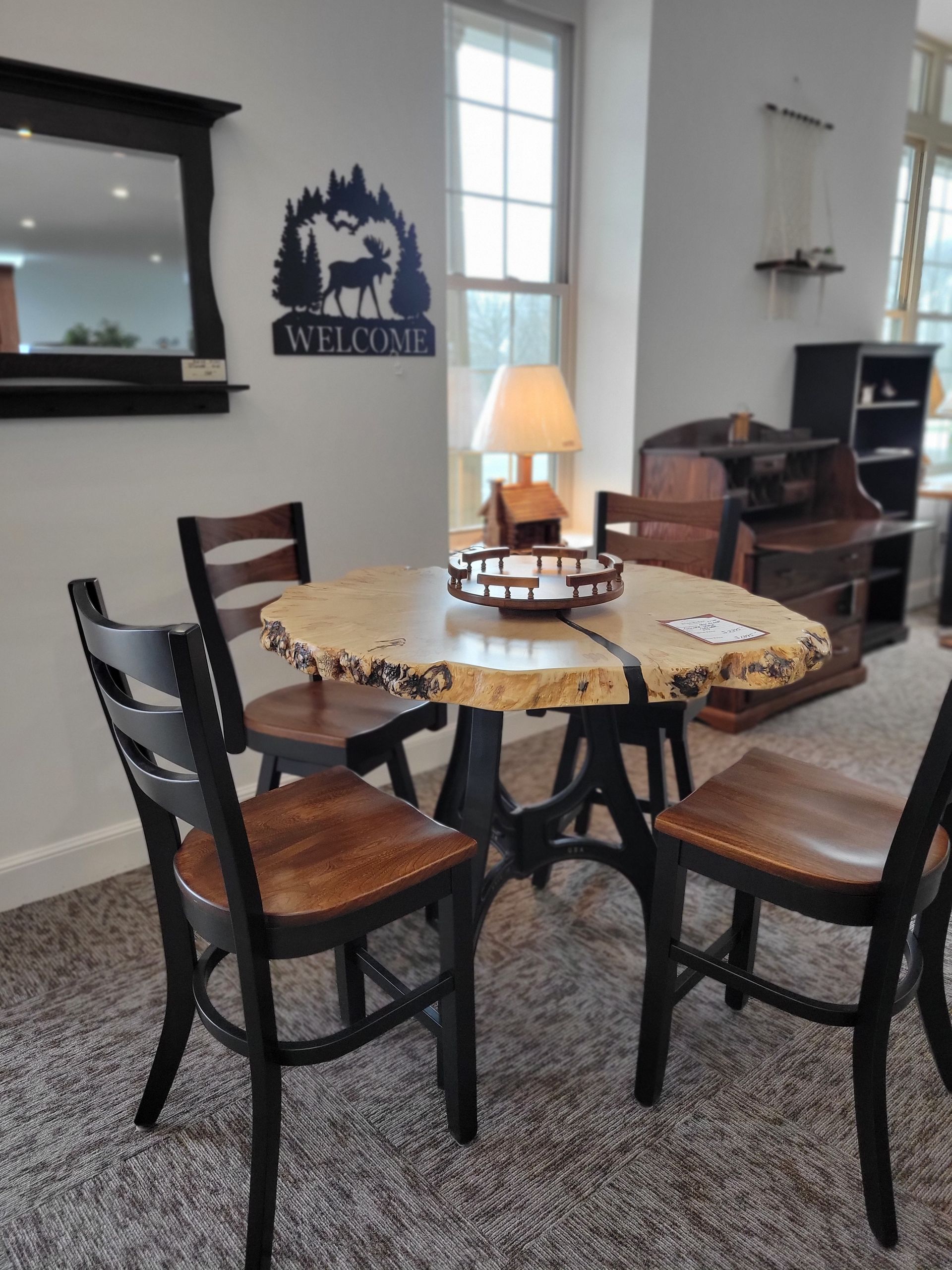 A room with a table and chairs and a sign that says welcome