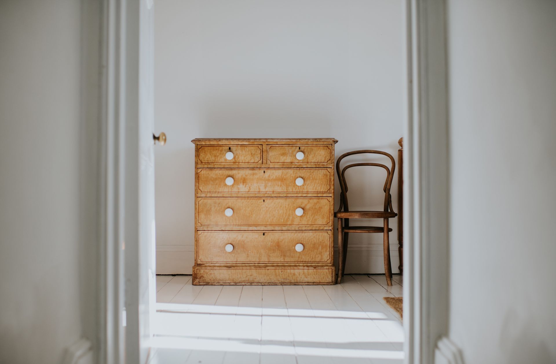 A wooden dresser topped with a decorative vase, showcasing elegant furniture design.
