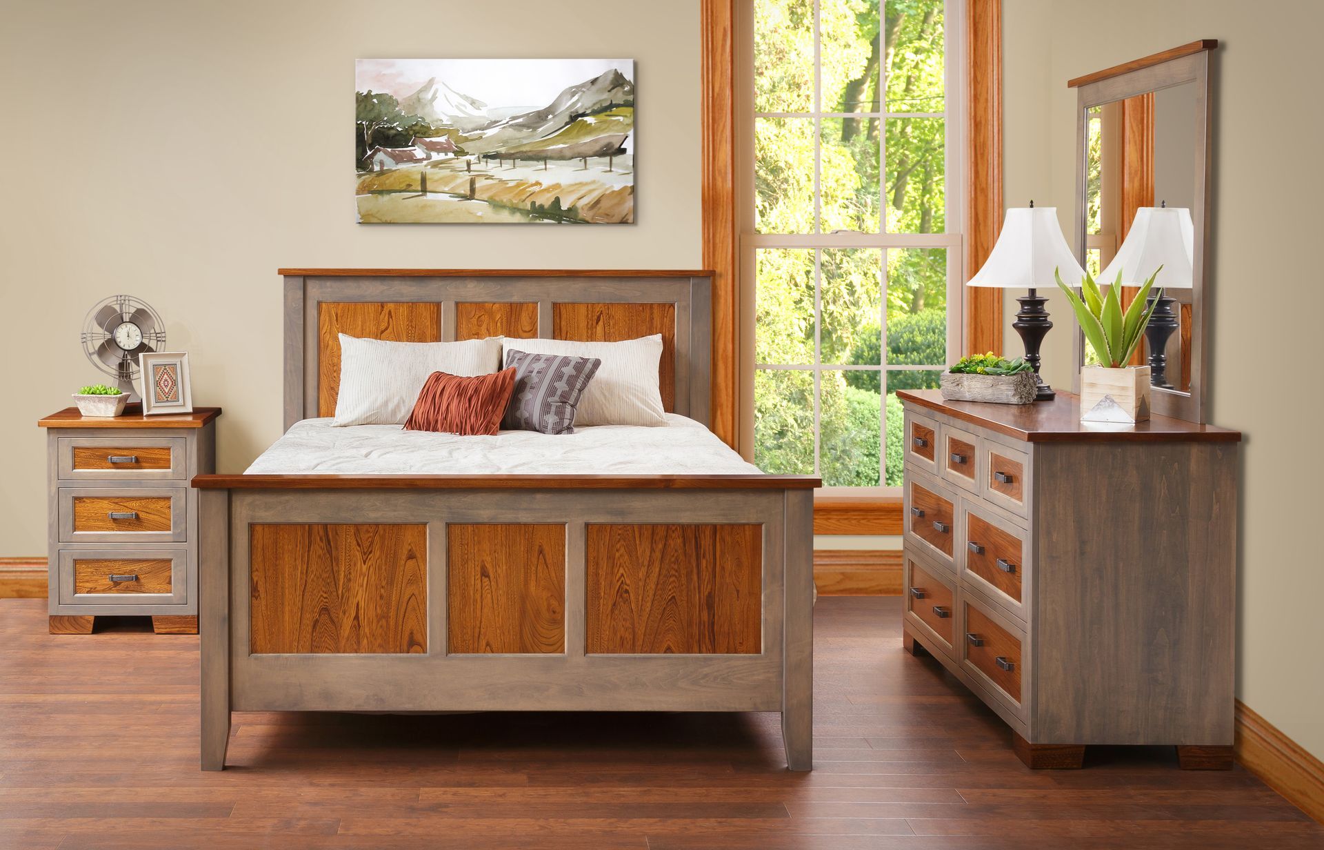 A bedroom with a bed , dresser , nightstand and mirror.