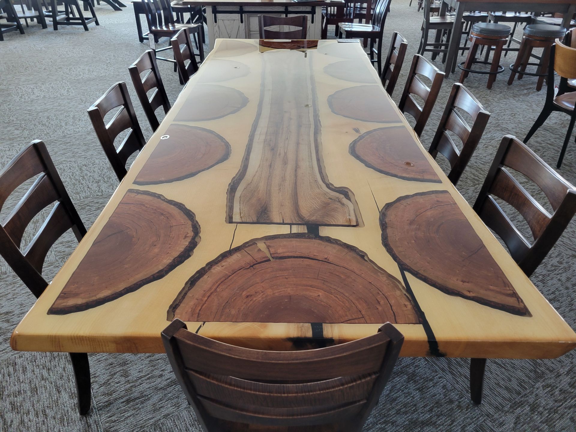 A long wooden table with a lot of chairs around it