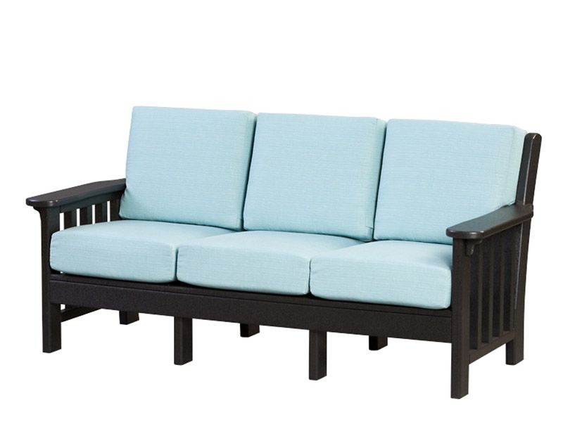 A black couch with blue cushions on a white background