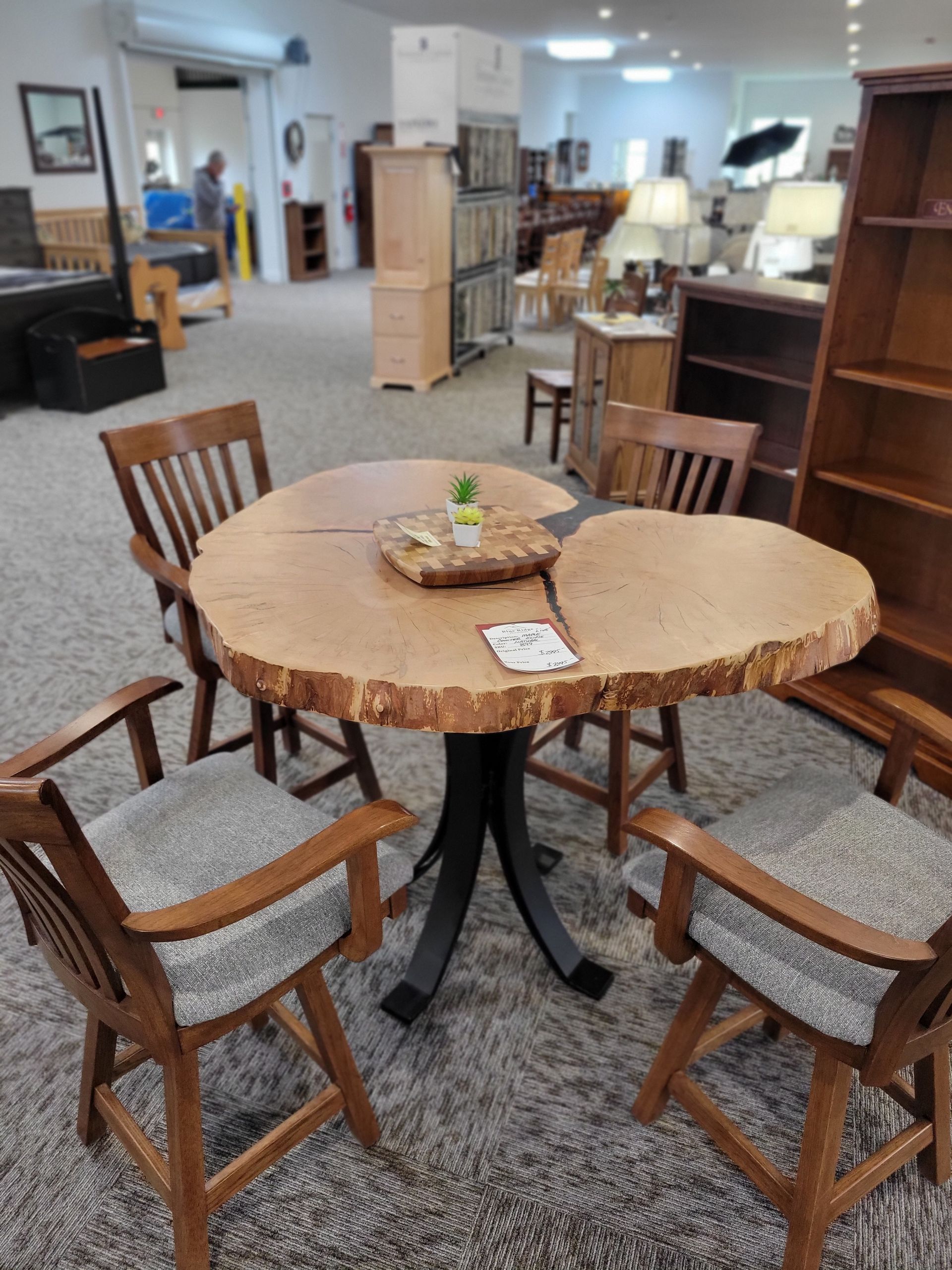 A wooden table and chairs are sitting in a room.