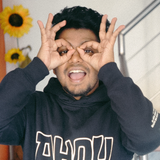 A man wearing a black sweatshirt with hebrew writing on it