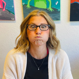 A woman wearing glasses is making a funny face