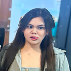 A woman with long hair is sticking her tongue out