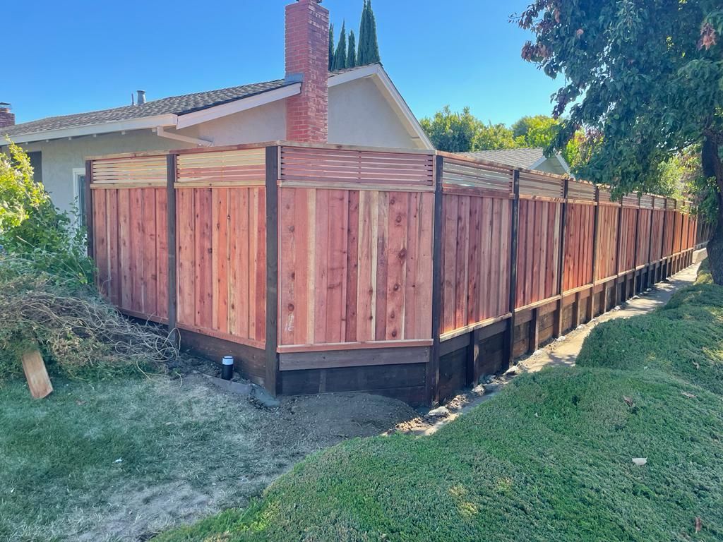 Redwood fence surrounds a residential backyard.