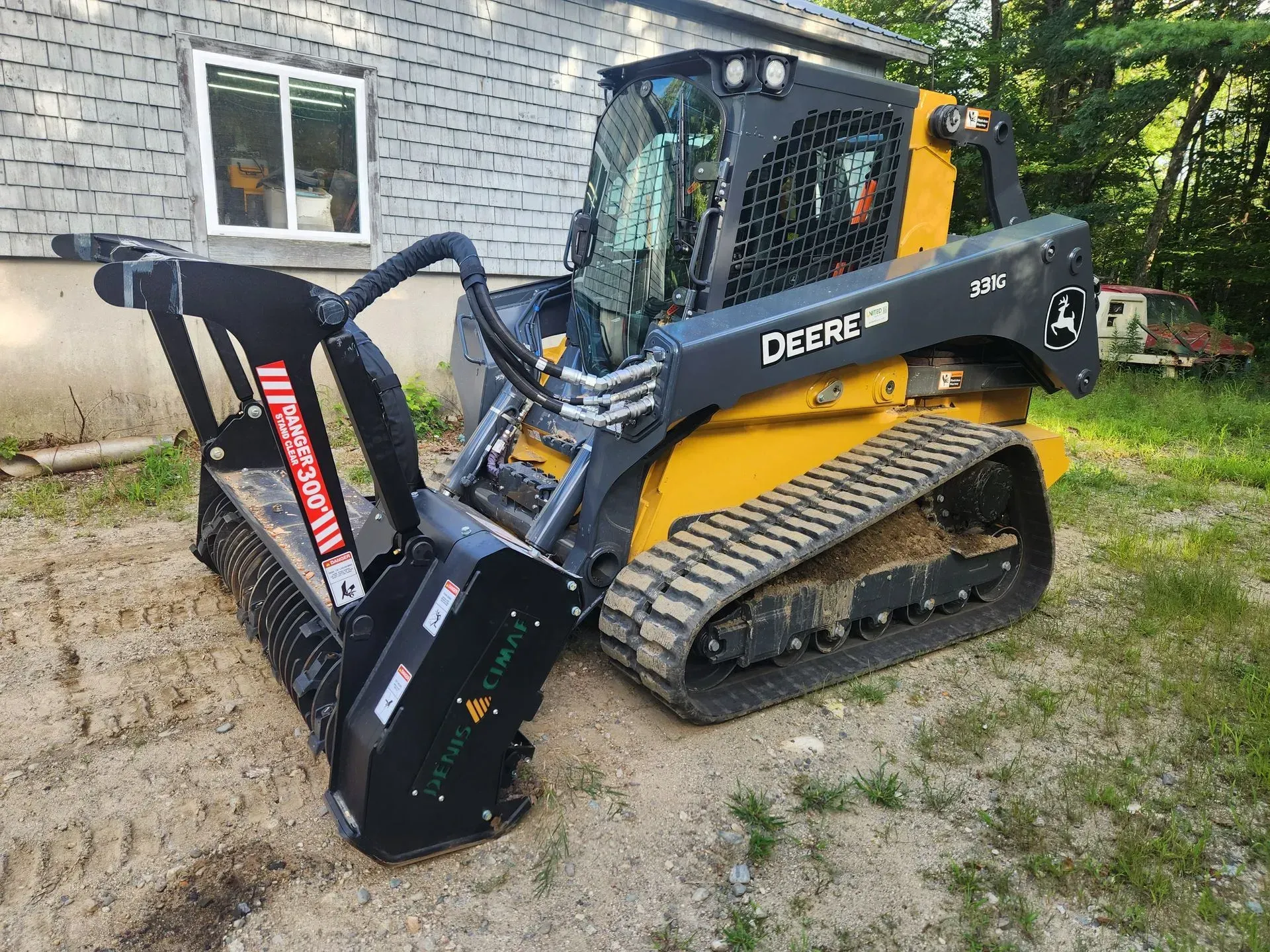 A bulldozer is cutting down trees in a forest.