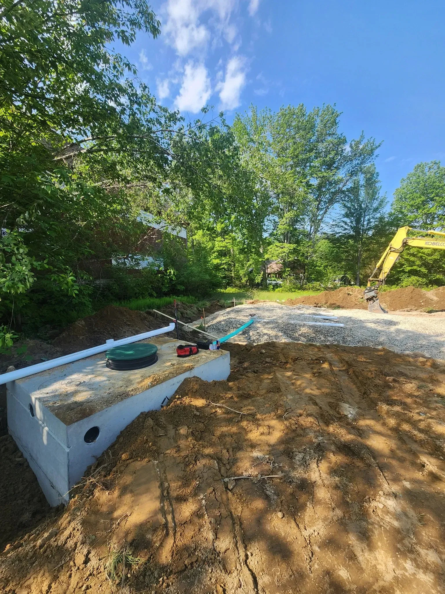 A septic tank is sitting in the middle of a dirt field.
