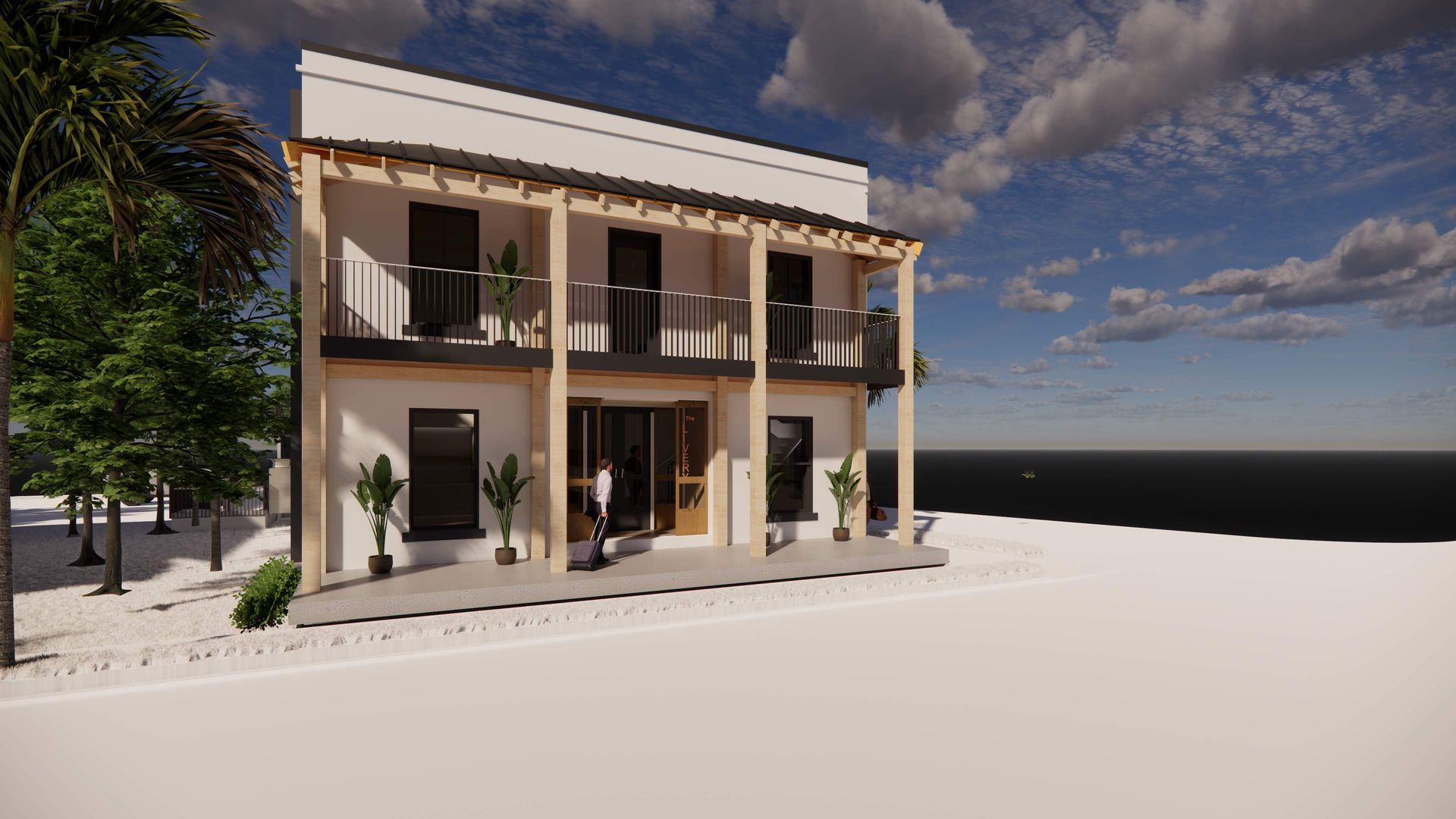 Two-story white building with wooden balcony and columns, beach setting. Person near the door.