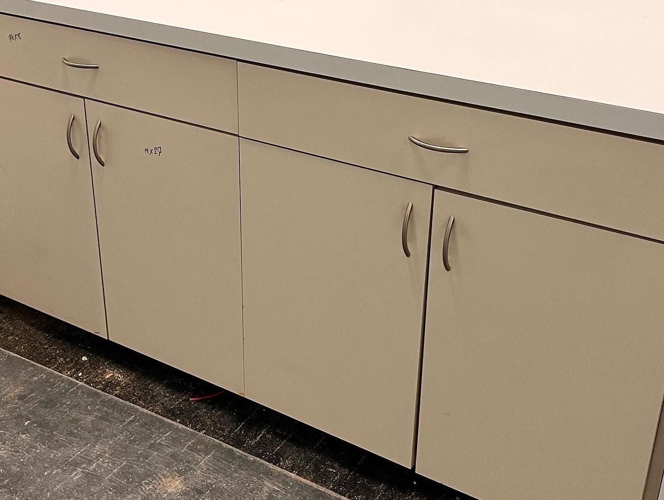 A row of cabinets with a gray counter top