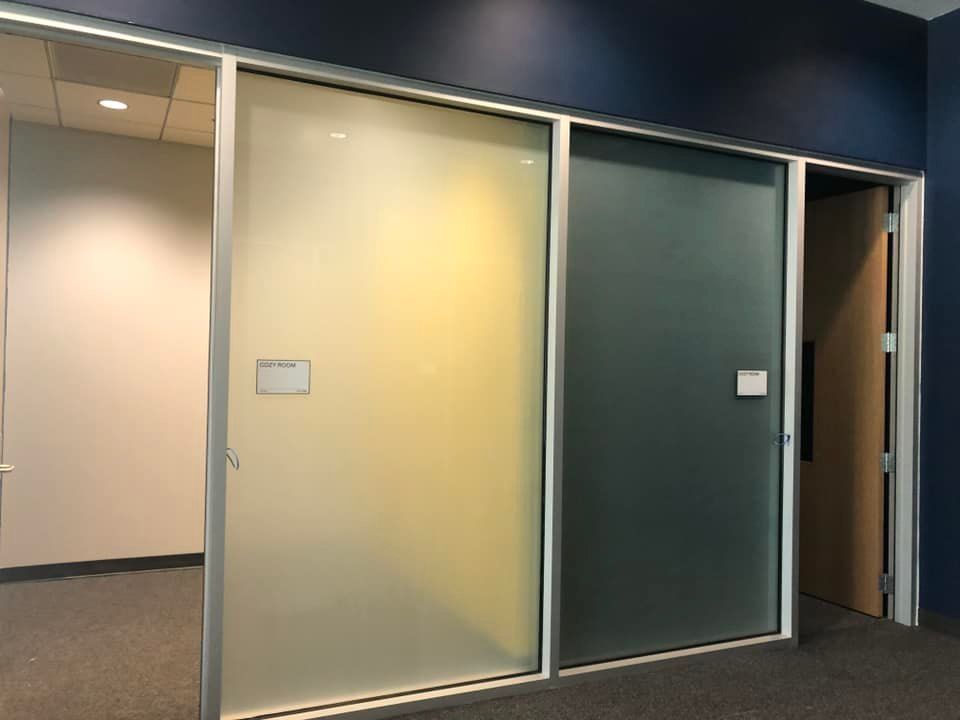 A room with sliding glass doors and a blue wall.