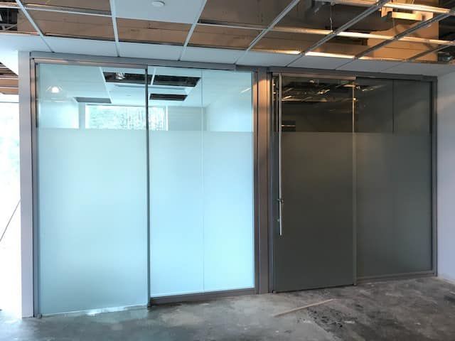 A room with sliding glass doors and frosted glass