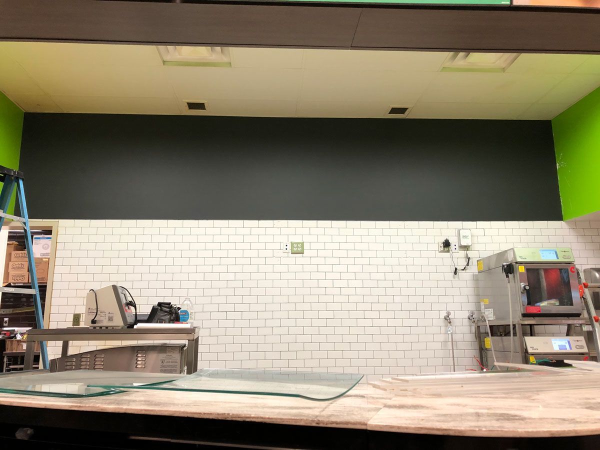 A kitchen with white brick walls and green walls is being remodeled.