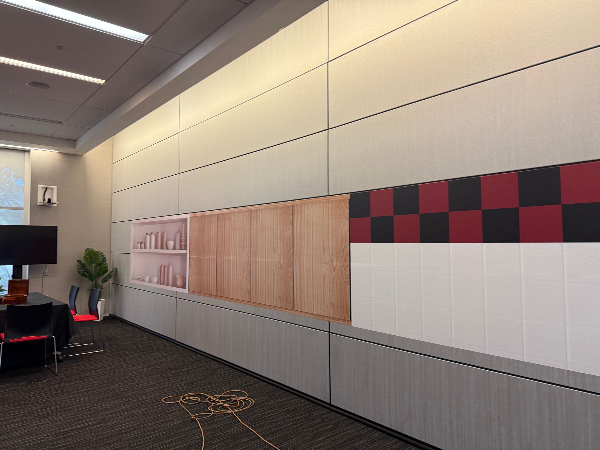 A large lobby with a reception desk and a flat screen tv.