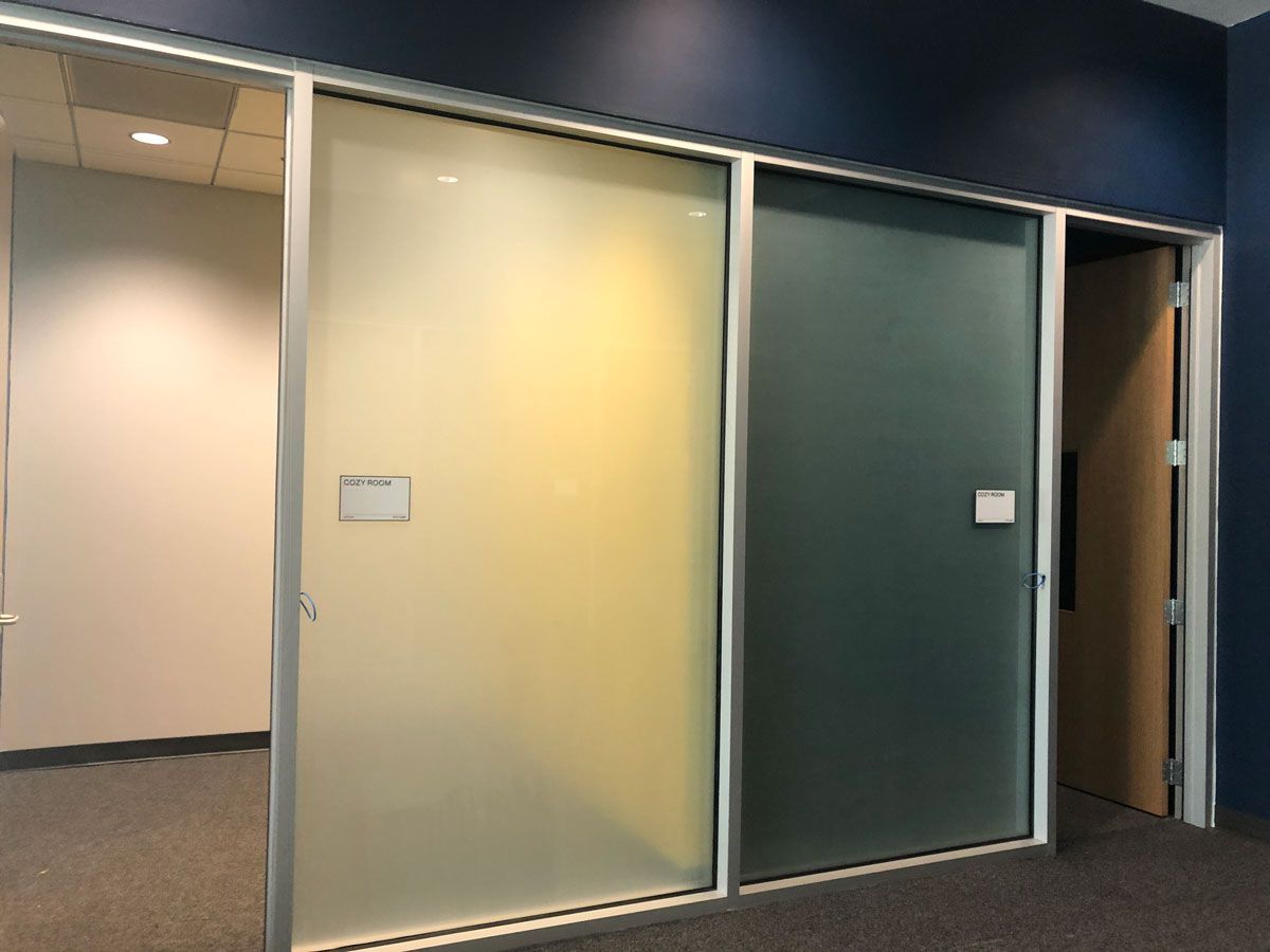 A room with sliding glass doors and a blue wall.