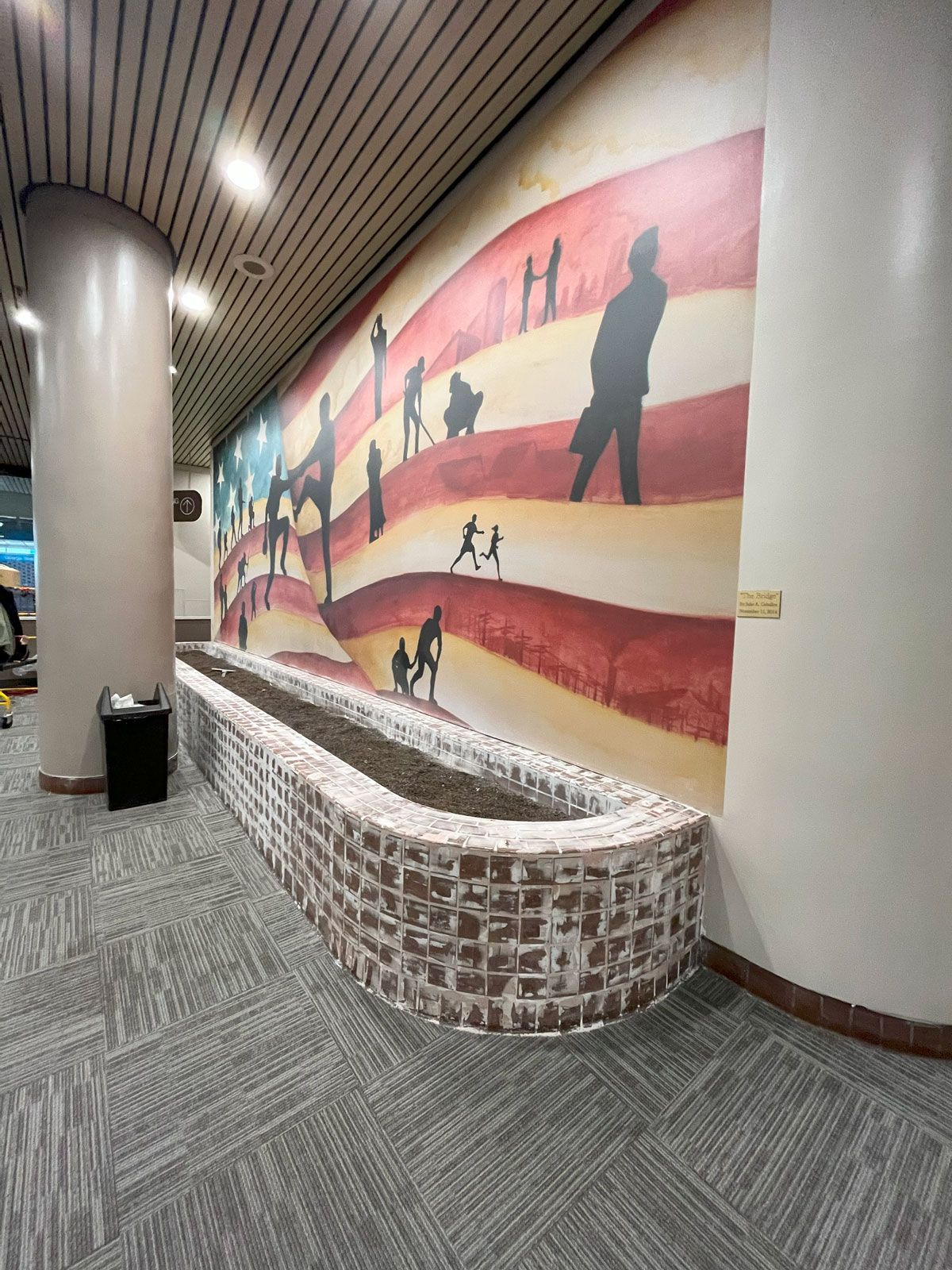 There is a large mural on the wall of a building.