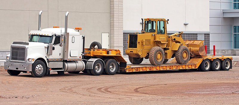 semi truck hauling bulldozer